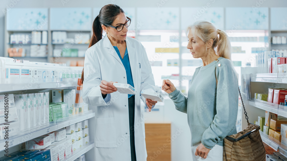 Obraz premium Pharmacy: Professional Specialist Pharmacist Helping Beautiful Senior Female Customer with Medicine Recommendation, Advice, Talking. Drugstore with Full of Drugs, Pills, Health Care, Beauty Products