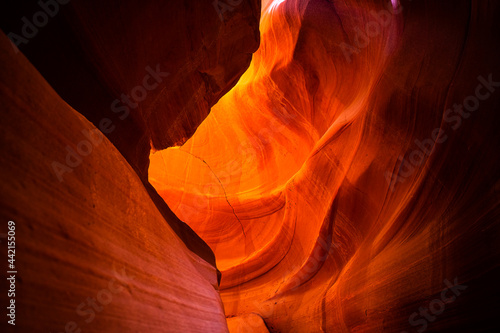 Looking up on upper Antelope slot canyon with red orange bright colorful layers of wave shape rock sandstone in Page, Arizona abstract background