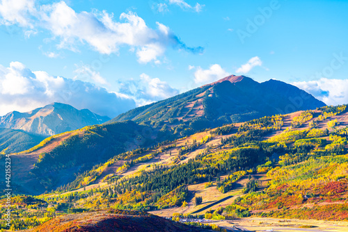 View of Aspen city, Colorado USA and buttermilk ski slope hill in rocky mountains peak with colorful autumn foliage aspen trees in Roaring fork valley