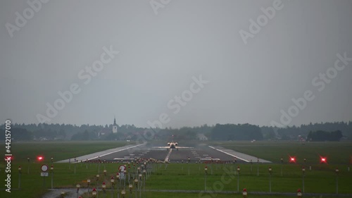 Private passenger airplane takeoff. Ljubljana airport, Slovenia. Small jet aircraft take off. Business jet is taking off. Static shot, real time