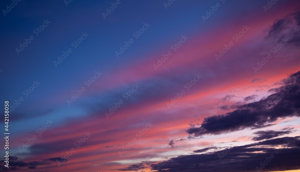 Multi-colored clouds on the dramatic sky. Consumption and sunset clouds. Natural landscape