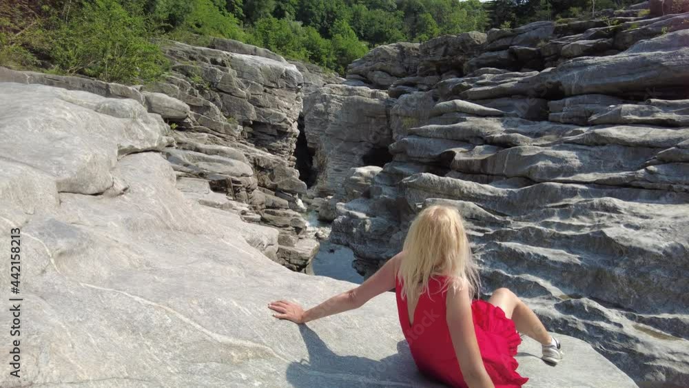 Woman among gorges of canyon of Aussichtspunkt Ponte Brolla bridge in Ticino Switzerland. Ponte Brolla is a famous attraction where you can sunbathing, canyoning and climbing. River Maggia by Locarno Woman among gorges of canyon of Aussichtspunkt Ponte Brolla bridge in Ticino Switzerland. Ponte Brolla is a famous attraction where you can sunbathing, canyoning and climbing. River Maggia by Locarno