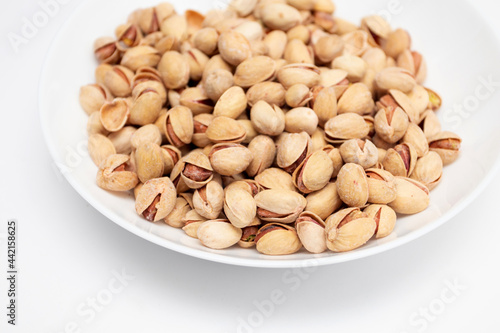 Pistachios nuts in white bowl