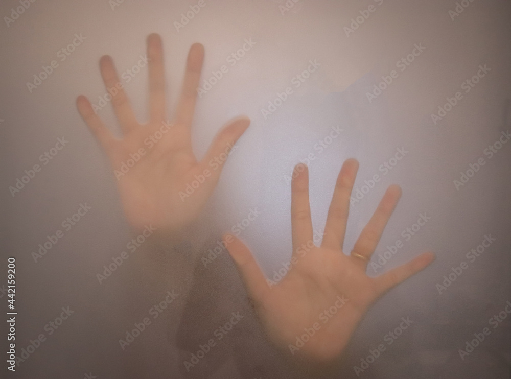 person seeks help by placing his hands on a glass