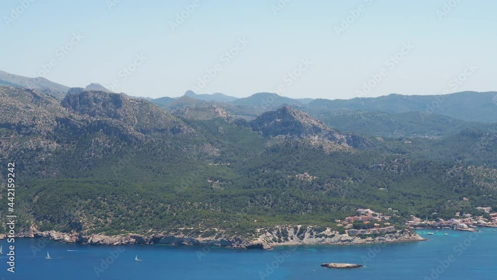 Panoramic view of coastline in Majorca island from the top of Sa Dragonera island in the mediterranean sea. Summer vacation and beach travel destination for yachts. Blue ocean with mountain range. Panoramic view of coastline in Majorca island from the top of Sa Dragonera island in the mediterranean sea. Summer vacation and beach travel destination for yachts. Blue ocean with mountain range.
