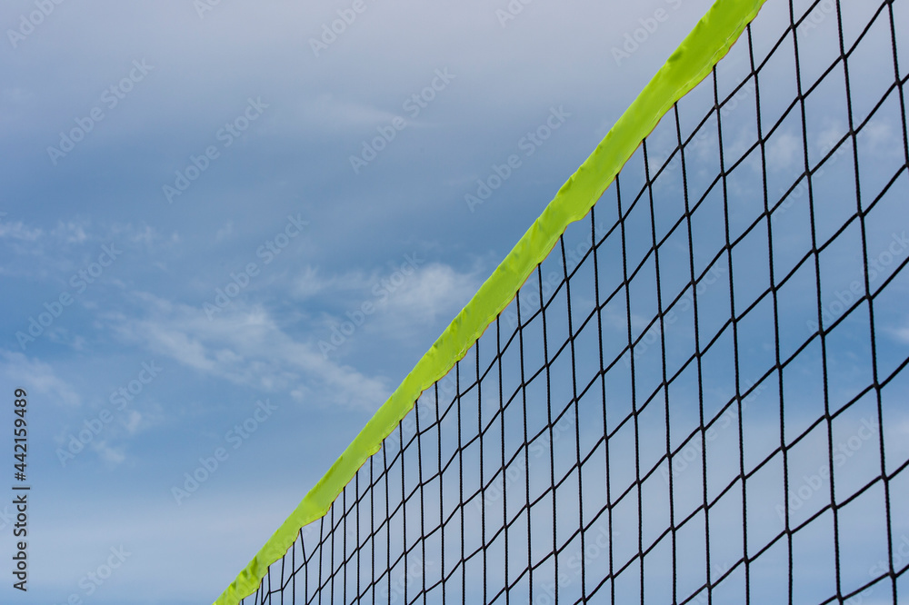 Beach volleyball and beach tennis net on the background of blue sky with clouds. Summer sport concept. Beach volleyball and beach tennis net on the background of blue sky with clouds. Summer sport concept.