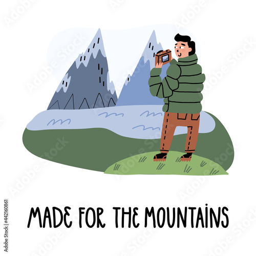 Nature professional photographer, tourist or blogger takes a pic of beautiful view, lettering Made for the mountains.