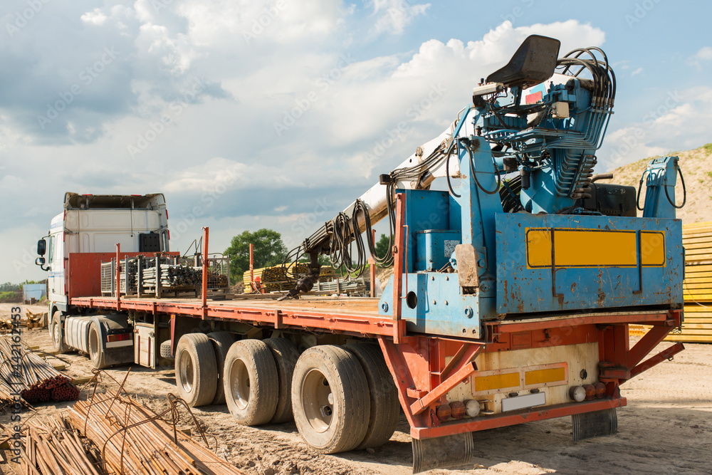 Obraz premium Truck with loader crane at construction site, rear view