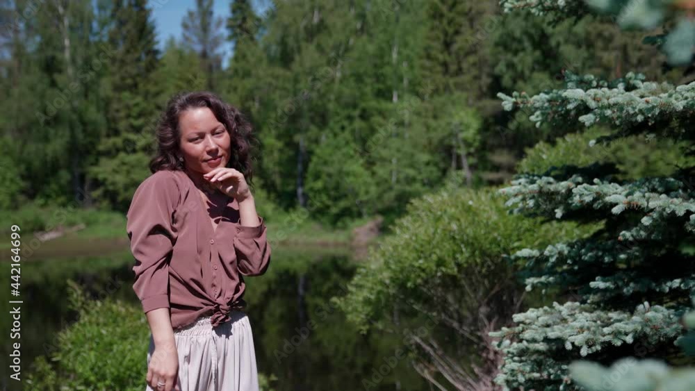 asian happy woman enjoys a sunny day in nature smiling at the sun asian happy woman enjoys a sunny day in nature smiling at the sun