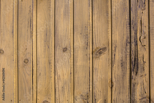 Vintage yellow wood background texture with knots and nail holes. Old painted wood wall © romeof