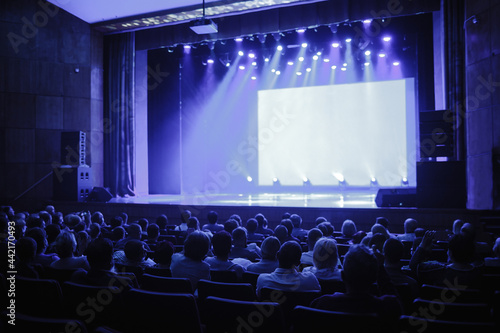 Business and Entrepreneurship concept. conference hall at business event. Audience at the conference hall. People are waiting for the speaker to speak and look at an empty stage