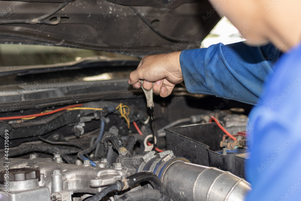 The mechanic is checking the engine. The mechanic is checking the engine.