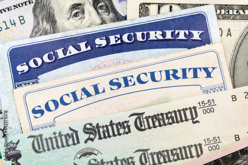Fotografía Macro view of Social Security cards, United States Treasury checks and cash