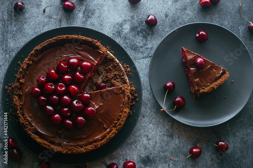 Pie with chocolate and cherries. Delicious cake on a plate