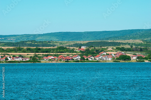 A beautiful village located on the banks of the Danube. Houses on the banks of the Danube river. © bogdan vacarciuc