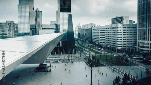 Time-lapse of Rotterdam station with skyscrapers. Pedestrians, cars and trams. High quality 4k footage
