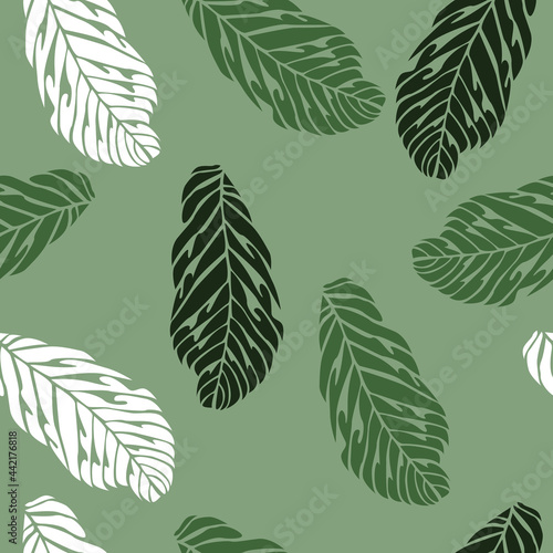Vector seamless pattern with green and white leaves on a green background.