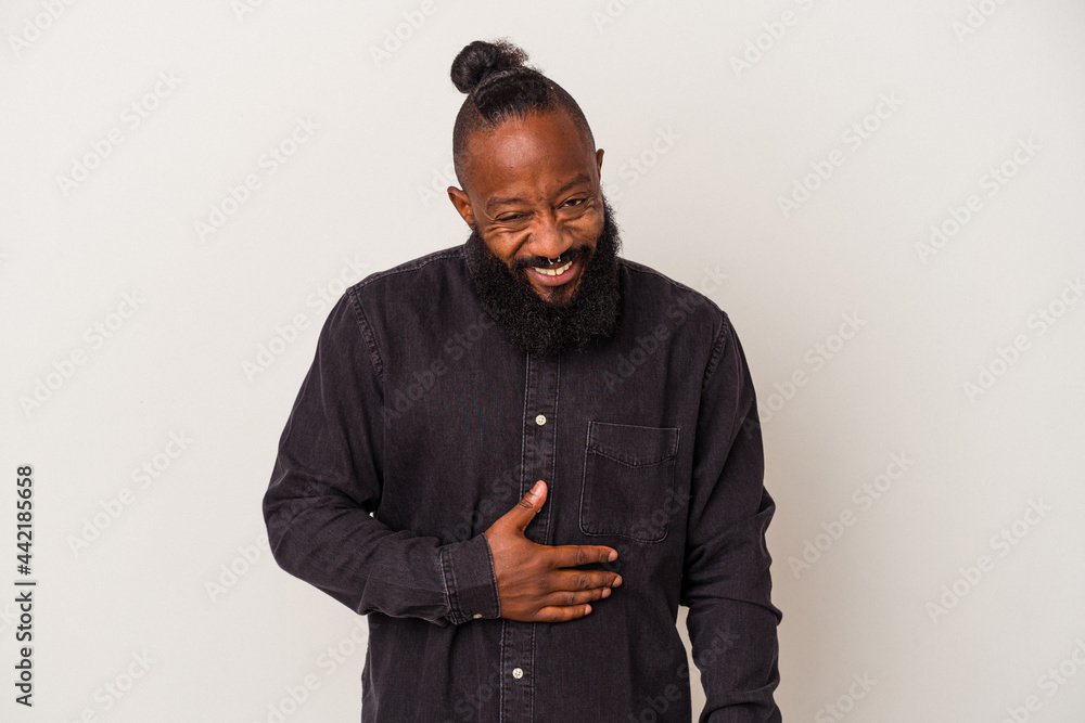 African american man with beard isolated on pink background touches tummy, smiles gently, eating and satisfaction concept. African american man with beard isolated on pink background touches tummy, smiles gently, eating and satisfaction concept.