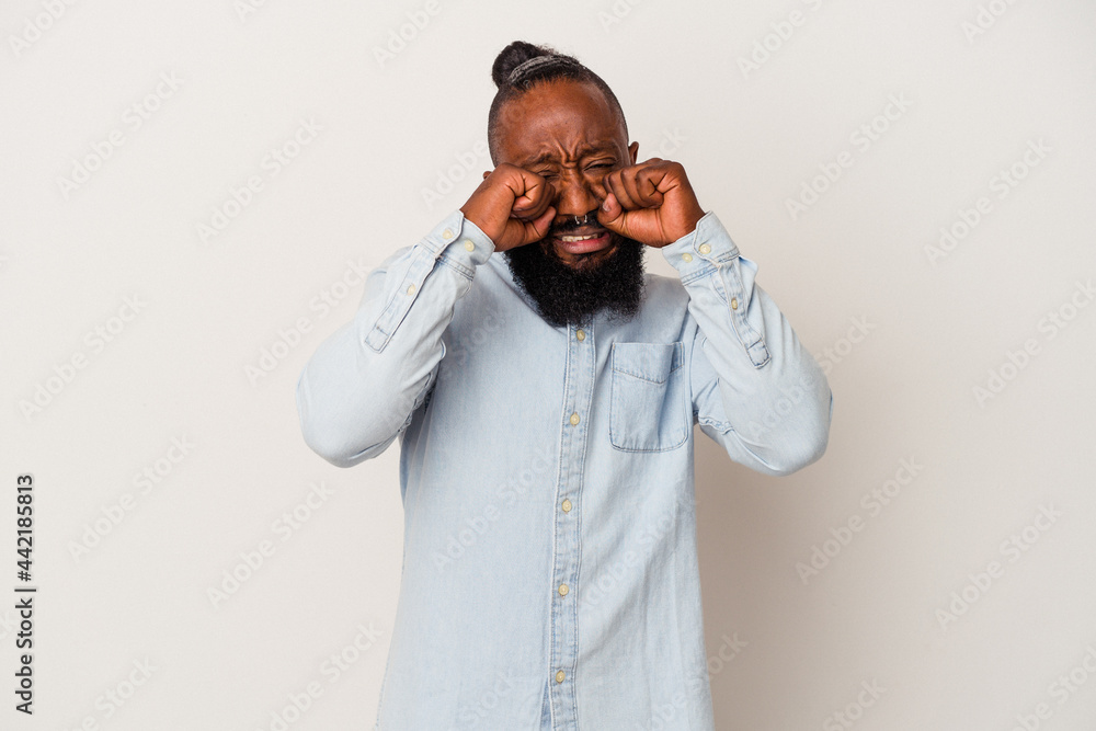 African american man with beard isolated on pink background whining and crying disconsolately. African american man with beard isolated on pink background whining and crying disconsolately.