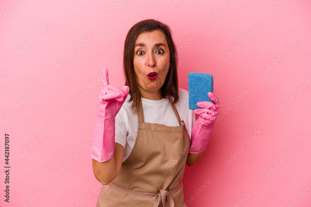Middle age caucasian woman cleaning home isolated on pink background having an idea, inspiration concept. Middle age caucasian woman cleaning home isolated on pink background having an idea, inspiration concept.