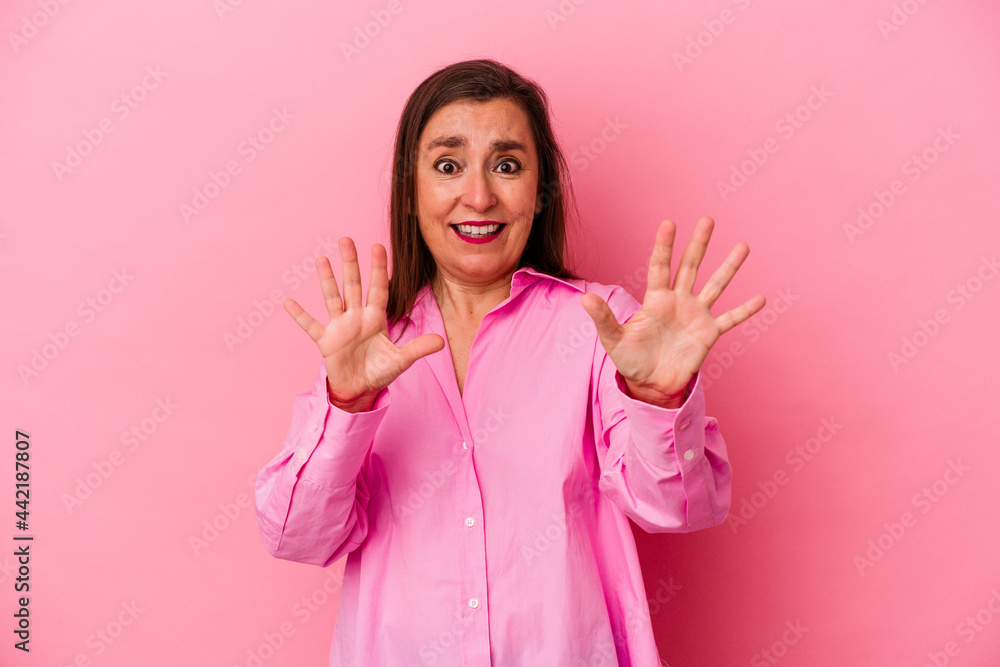 Middle age caucasian woman isolated on pink background rejecting someone showing a gesture of disgust. Middle age caucasian woman isolated on pink background rejecting someone showing a gesture of disgust.