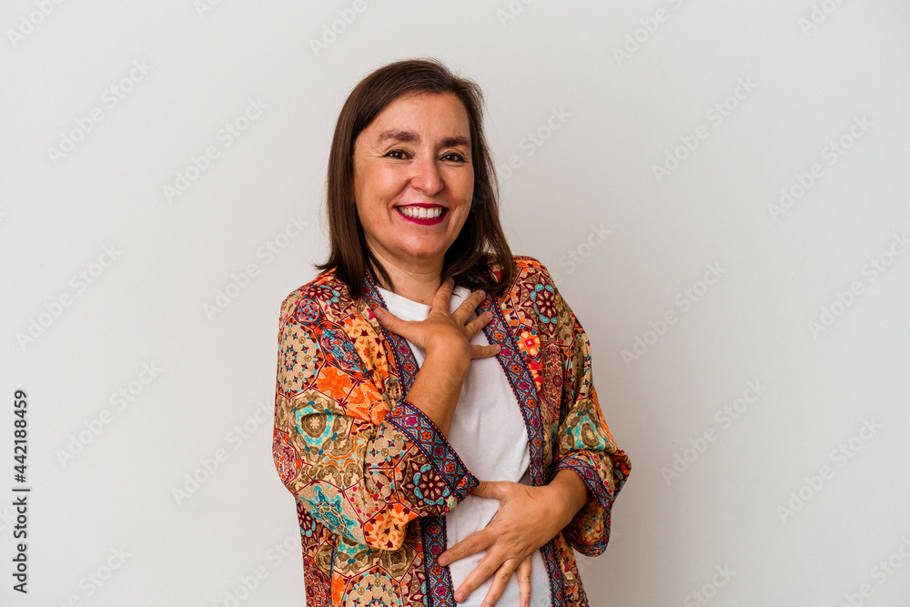 Middle age caucasian woman isolated on white background laughs happily and has fun keeping hands on stomach. Middle age caucasian woman isolated on white background laughs happily and has fun keeping hands on stomach.