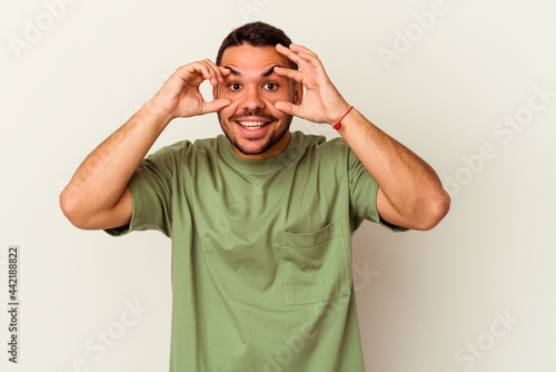 Young caucasian man isolated on white background keeping eyes opened to find a success opportunity.