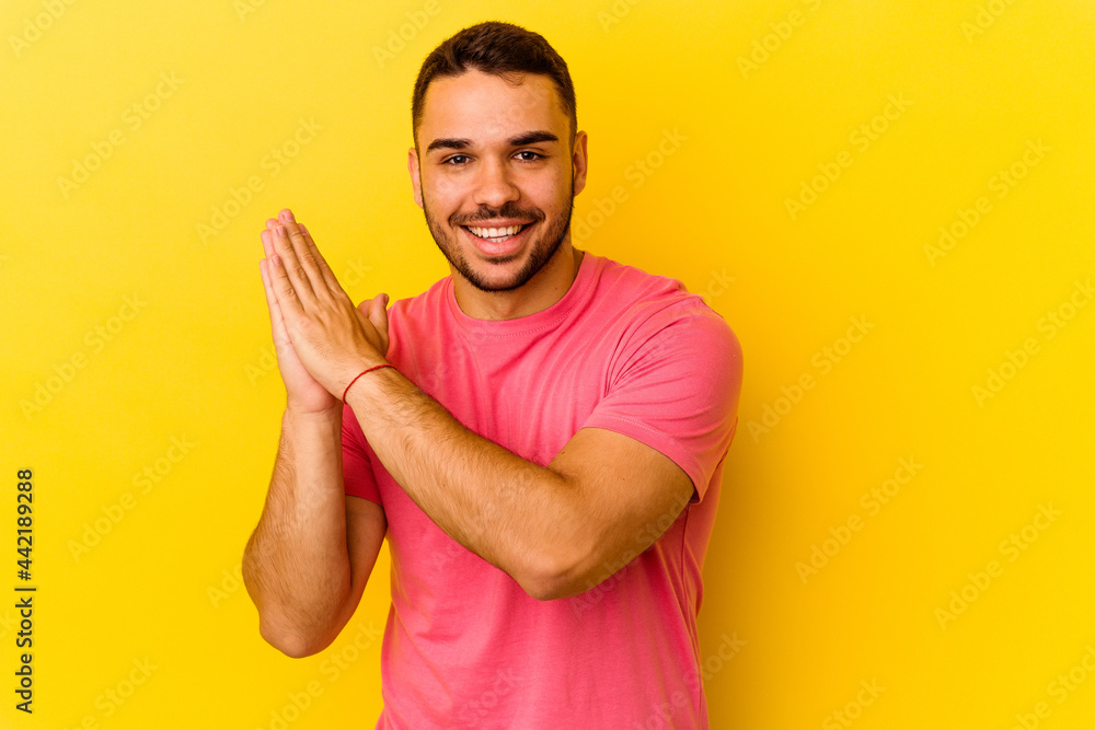 Young caucasian man isolated on yellow background feeling energetic and comfortable, rubbing hands confident. Young caucasian man isolated on yellow background feeling energetic and comfortable, rubbing hands confident.
