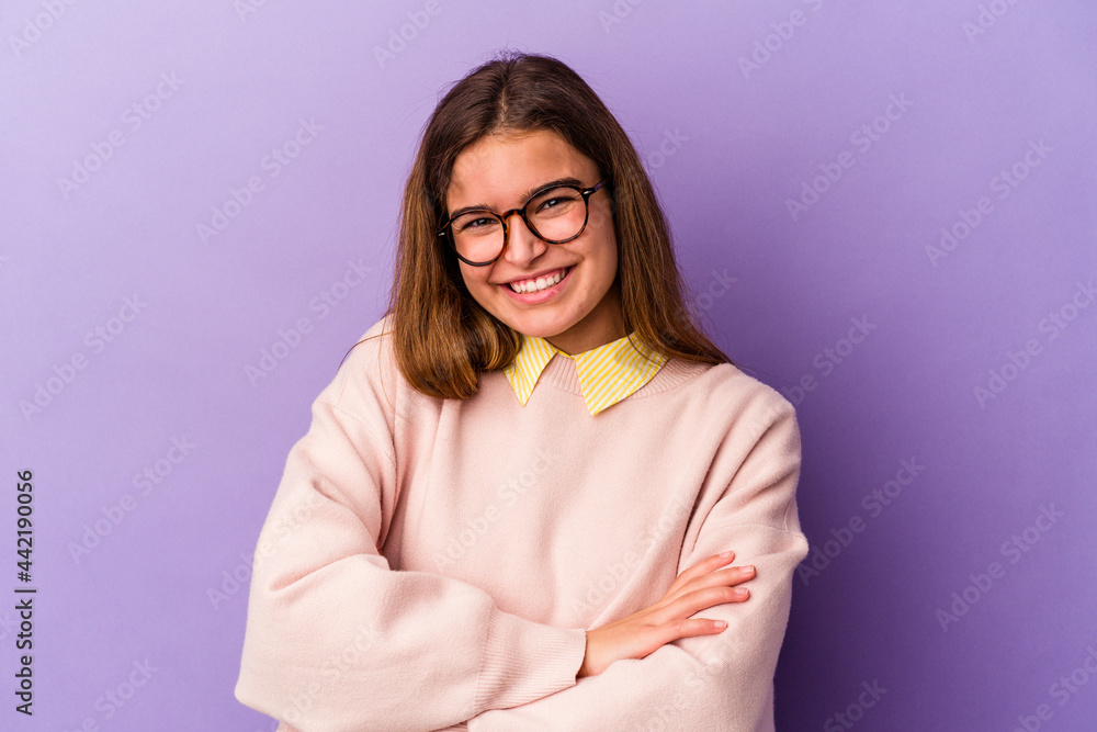 Young caucasian woman isolated on purple background who feels confident, crossing arms with determination.