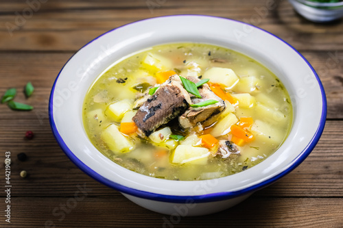 Low calorie vegetable fish soup on wooden rustic background. Space for text.
