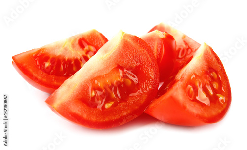 Pieces of ripe red tomato are isolated on a white background. Full clipping path.