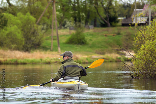 portrait kayaker on river forest landscape and reflections