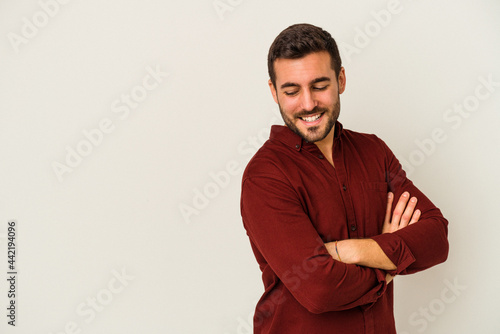 Young caucasian man isolated on white background smiling confident with crossed arms.