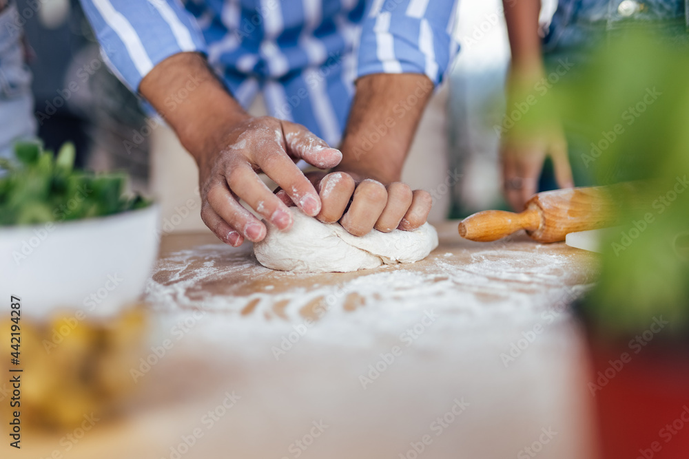 Picture of a chef, preparing pizza ingredients.