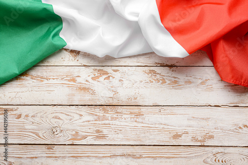 Italian flag on light wooden background