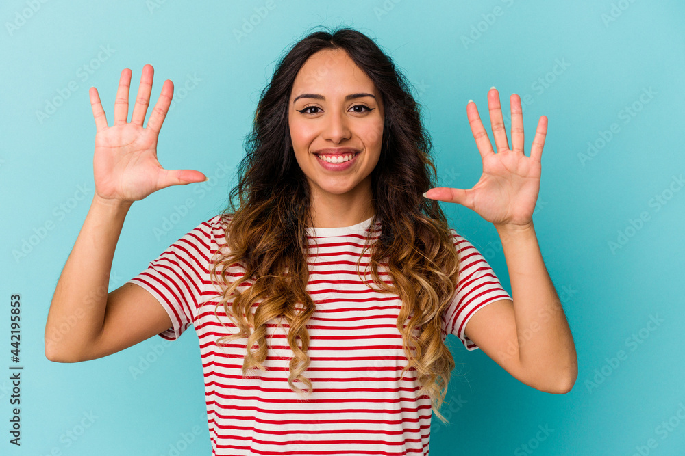 Young mexican woman isolated on blue background showing number ten with hands. Young mexican woman isolated on blue background showing number ten with hands.