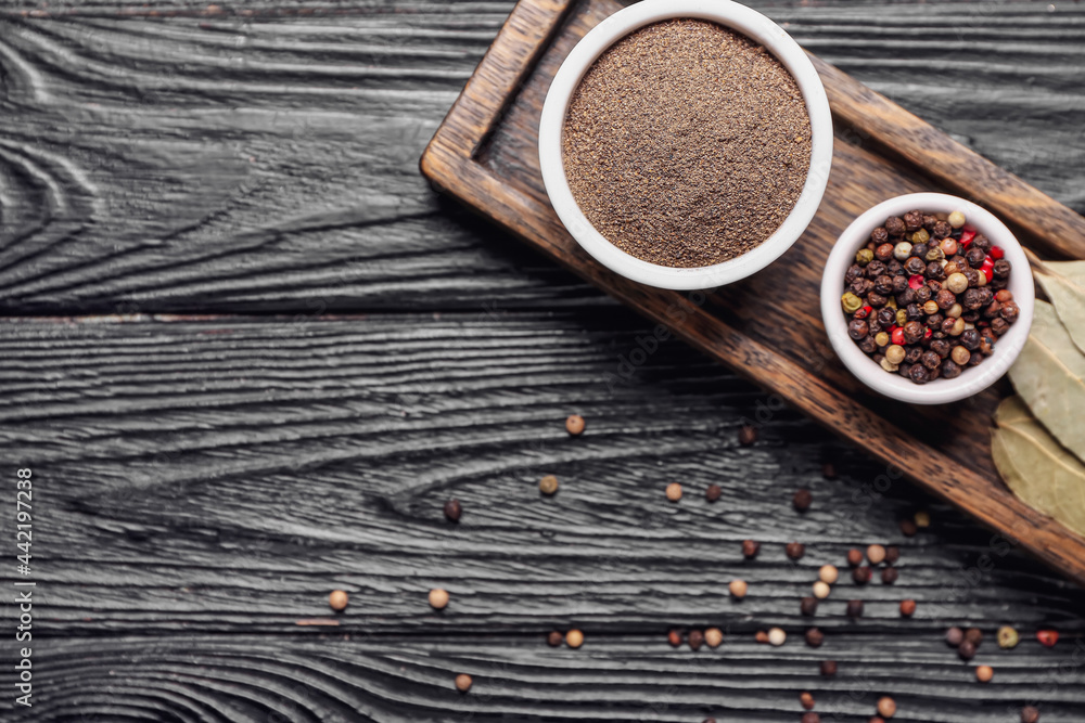 Tray with different spices on dark wooden background Tray with different spices on dark wooden background