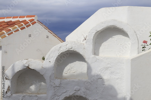 White cemetery and a rose in Andalusian village, Spain photo