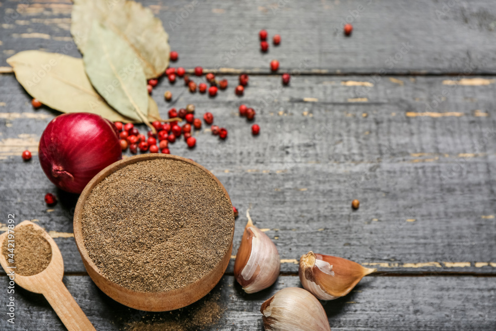 Composition with black pepper powder on dark wooden background Composition with black pepper powder on dark wooden background