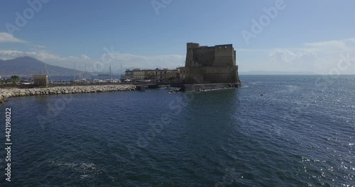 Aerial Drone footage view of Castle Dell’Ovo in Naples Italy seaport sea evening  // no video editing

