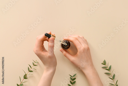 Female hands with bottle of...