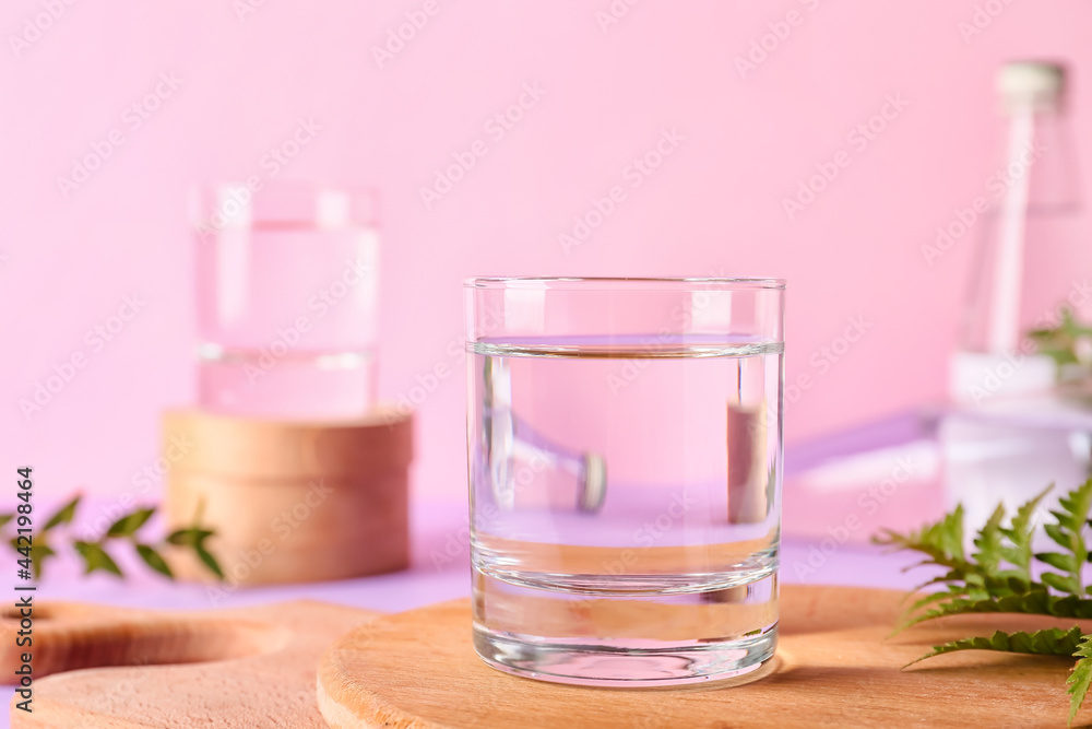 Glass of water on color background, closeup