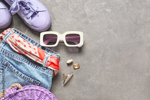 Set of female accessories with sunglasses on grey background