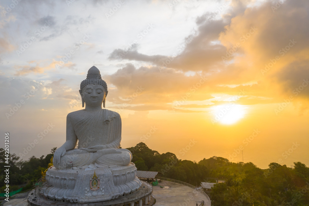 aerial view scenery yellow sun with rain clouds moving summer..beautiful Phuket big Buddha on the top of mountain.. Another incentive to attract tourists to visit. popular landmark of Phuket aerial view scenery yellow sun with rain clouds moving summer..beautiful Phuket big Buddha on the top of mountain.. Another incentive to attract tourists to visit. popular landmark of Phuket