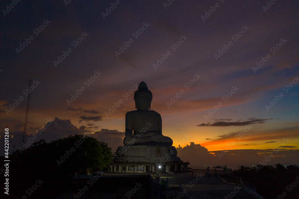 aerial view scenery sunset with rain clouds moving summer..beautiful silhouette Phuket big Buddha on the hilltop.. Another incentive to attract tourists to visit. popular landmark of Phuket aerial view scenery sunset with rain clouds moving summer..beautiful silhouette Phuket big Buddha on the hilltop.. Another incentive to attract tourists to visit. popular landmark of Phuket