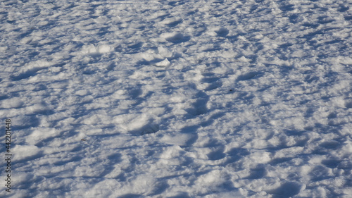 Blue trampled snow. Snow background, winter light blue background.