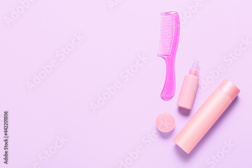 Hair comb and cosmetics on color background