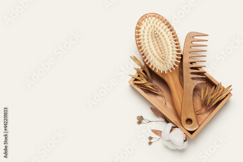 Fotografie Box with hair brush and comb on color background