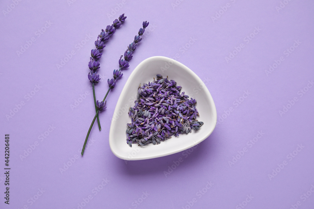 Fototapeta Beautiful lavender flowers and bowl on color background