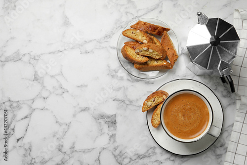 Canvastavla Flat lay composition with tasty cantucci and aromatic coffee on white marble table, space for text